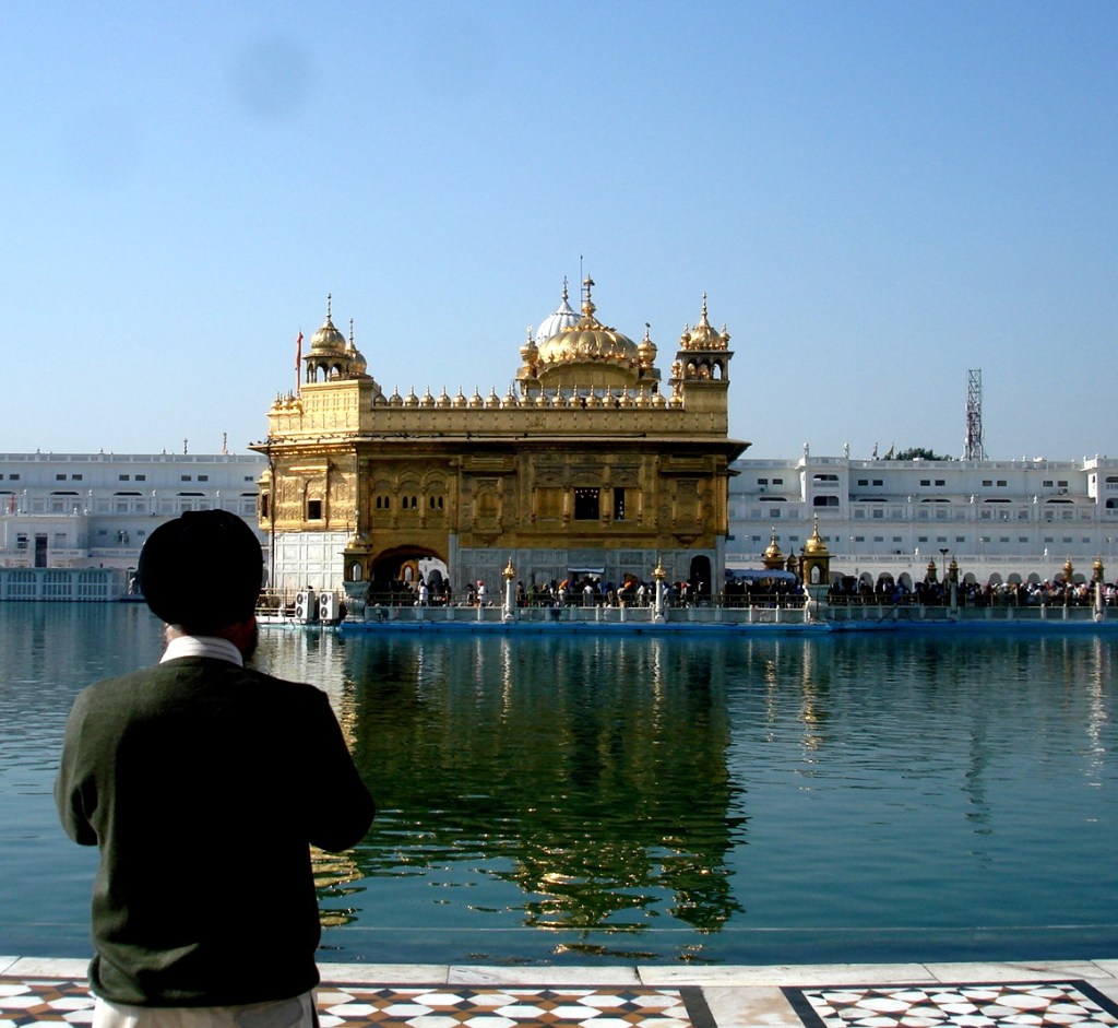 A follower offering prayers to the Golden Temple