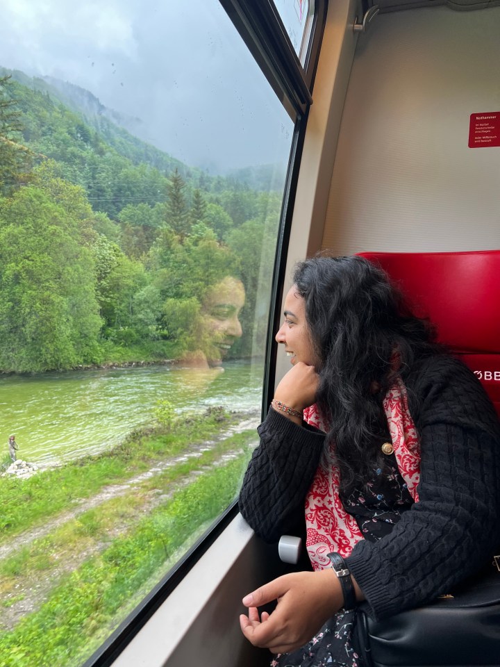 My friend Pooja enjoying the scenic view from the train to Hallstatt